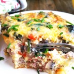 This breakfast casserole is perfect for holiday brunch! It is loaded with a crescent roll crust, sausage, bacon, mushrooms, spinach and colby jack cheese.