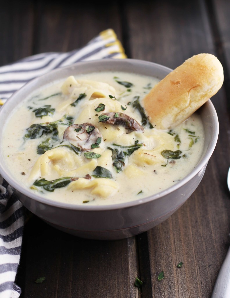 This Slow Cooker Creamy Tortellini Spinach and Mushroom Soup is the perfect way to warm up this winter.  It is loaded with cheese tortellini and is so creamy, dreamy and delightful! It is also easily made as a vegetarian soup by substituting vegetable broth.  