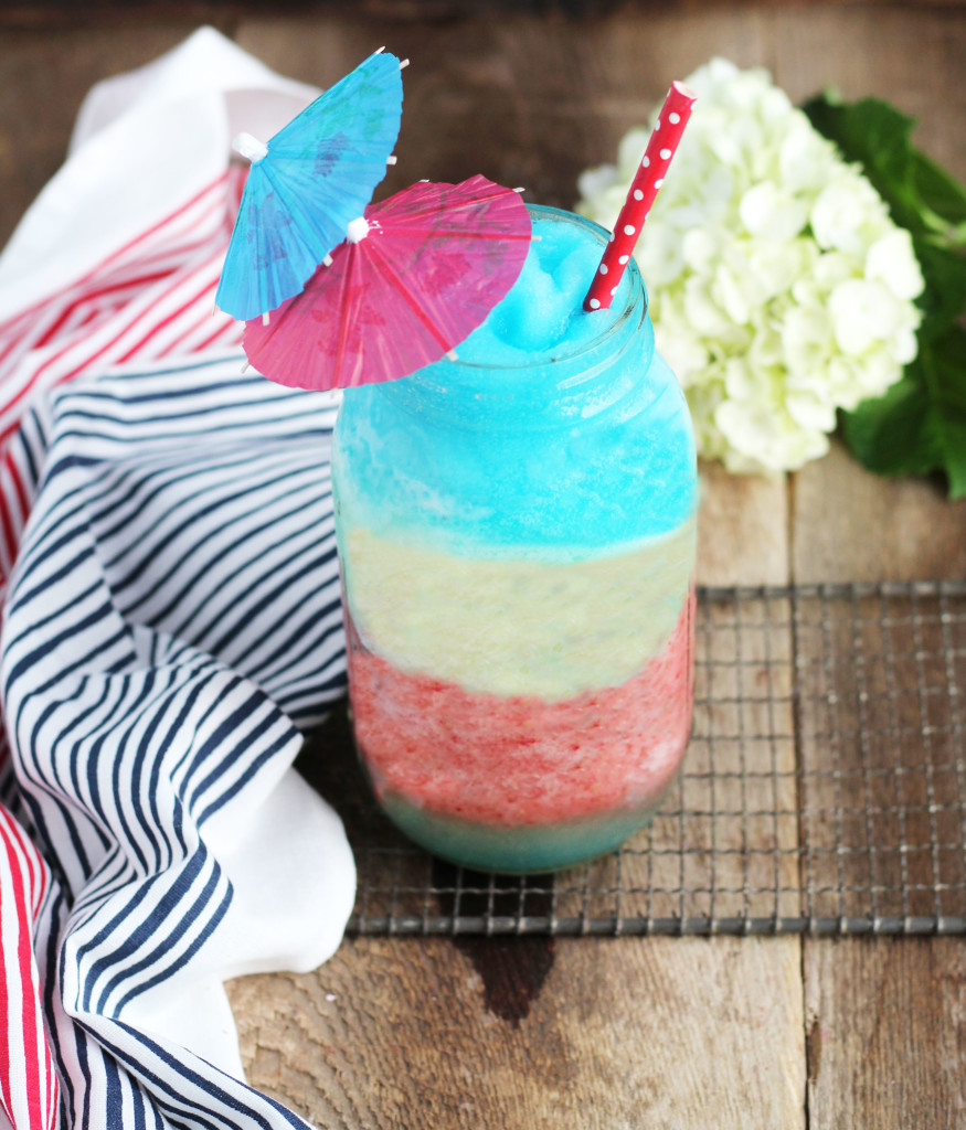 This Red White and Blue Pina Colada is such a great flavor combination that gets even better as the layers bleed together.  It has the classic Pina Colada flavors with the addition of strawberry and Blue Curacao.    