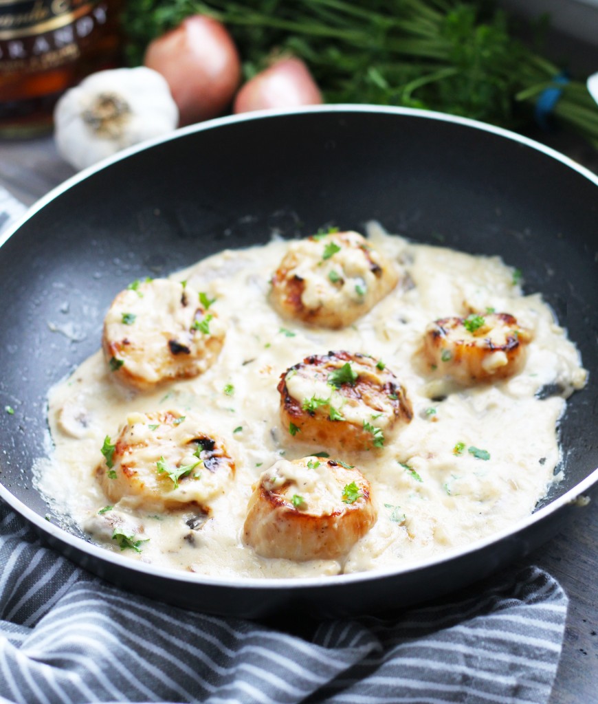 Scallops in Brandy Mushroom Cream Sauce are my favorite aphrodisiac to prepare for dinner on Valentine's Day (with a side of lobster tail)!  These are so easy to make and are on the table in under 30 minutes.  Serve them with a side of sautéed spinach and your favorite potatoes for a decadent dinner that screams, "I love you".