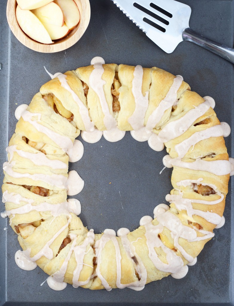 This Apple Crescent Roll Pastry Ring is so easy to throw together with ready-made crescent rolls and fresh apples.  A maple and cinnamon glaze top of this delightful confection.  Substitute with your favorite pie fillings for an even quicker preparation.