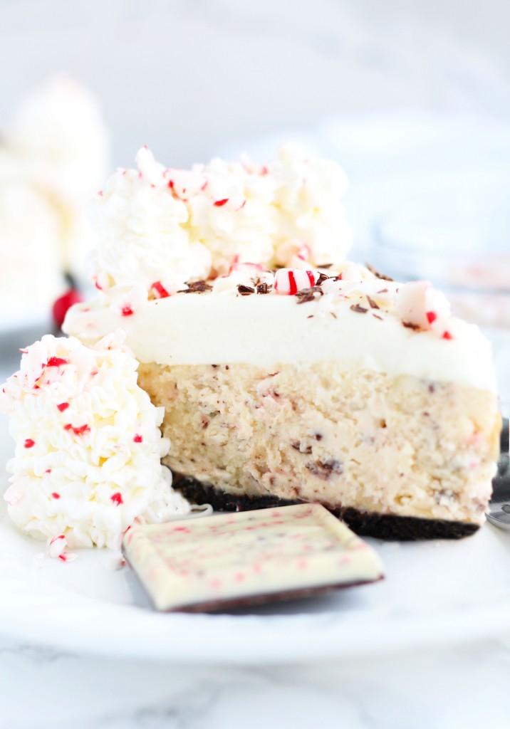 A festive, White Chocolate Cheesecake with the flavors of peppermint bark and a white chocolate mousse topping.