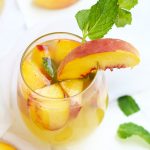 A Fuzzy Navel Peach Sangria is a celestial medley of everything that is right in this world.  Plenty of fresh peaches get combined with a bottle of white Moscato, orange juice, peach schnapps, and vodka.  