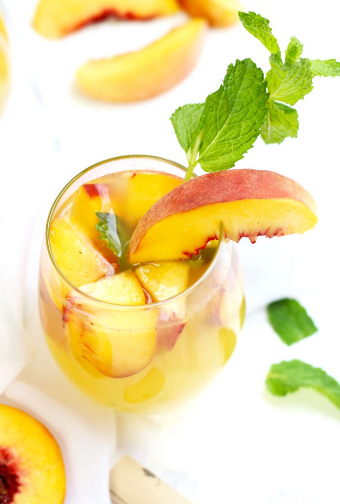 A Fuzzy Navel Peach Sangria is a celestial medley of everything that is right in this world.  Plenty of fresh peaches get combined with a bottle of white Moscato, orange juice, peach schnapps, and vodka.  