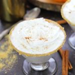 Drink your fall dessert with this decadent pumpkin pie martini with a graham cracker rim and whipped cream topping.