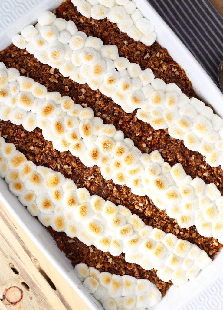 This Sweet Potato Casserole with Pecan Topping is easily put together the night before for a no fuss Thanksgiving day side dish.  The delectable brown sugar and pecan topping adds the perfect balance of soft and crispy textures.  Rows of marshmallows can be added for added sweetness and color.