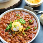 This Slow Cooker Beer Chili is easily made with ground beef or turkey.  A bottle of your favorite beer gets added with pinto beans, onion, tomato, jalepeno pepper and spices.  This recipe is perfect for game day entertaining.