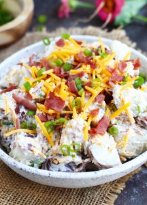 This Loaded Potato Salad is a great, easy side dish for your summer barbecues. A sour cream and ranch mixture add plenty of flavor with a bacon, cheddar cheese and green onion topping.