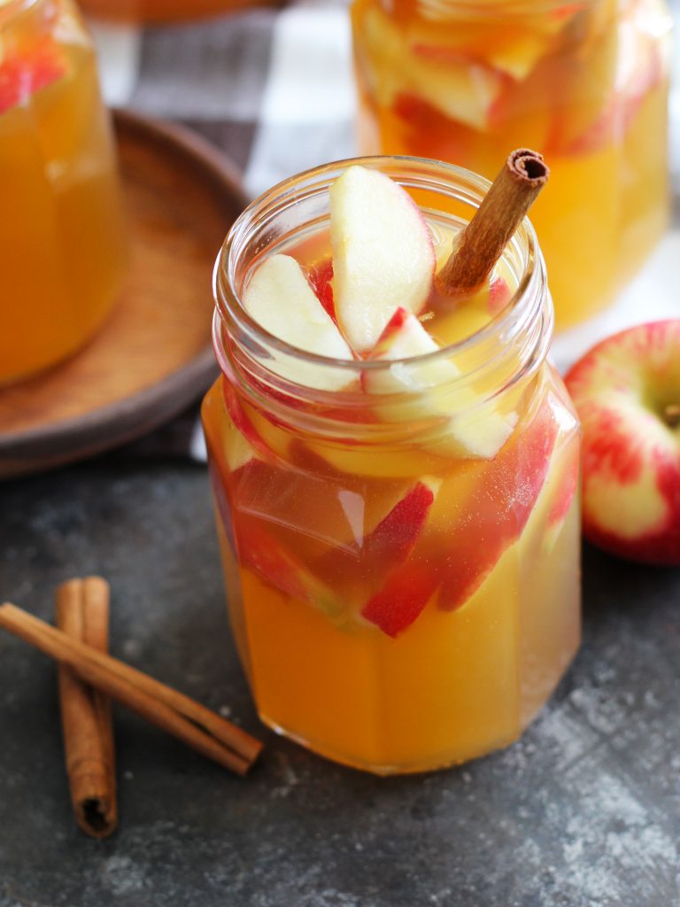 This Fireball Apple Cider Sangria is the perfect fall party cocktail. Fresh apples and cinnamon sticks add to this flavorful cocktail with apple cider, Pinot Grigio, Fireball Cinnamon Whisky and a splash of ginger ale.