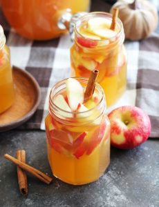 This Fireball Apple Cider Sangria is the perfect fall party cocktail. Fresh apples and cinnamon sticks add to this flavorful cocktail with apple cider, Pinot Grigio, Fireball Cinnamon Whisky and a splash of ginger ale.