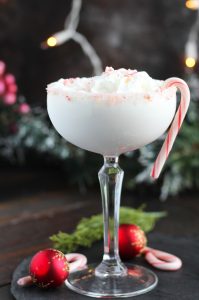 This Candy Cane Martini is so fun for the holidays with vanilla vodka and peppermint schnapps.  A floating of whipped cream with a candy cane rim and top make this dessert martini a festive treat.