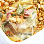 This Cheesy Bacon Green Bean Casserole has so much more flavor than the traditional cream of mushroom soup version. Plenty of Velveeta and Colby Jack cheese gets added to this cheesy sauce with a pack of bacon and crispy, cracker topping.  