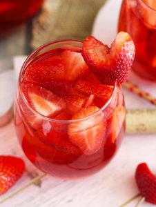 This Strawberry Rose Sangria is a refreshing cocktail with Strawberry Schnapps, vanilla vodka, fresh strawberries and a splash of soda. Garnish with heart-shaped strawberries for your sweetheart.