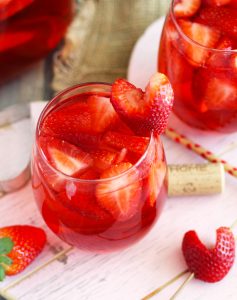 This Strawberry Rose Sangria is a refreshing cocktail with Strawberry Schnapps, vanilla vodka, fresh strawberries and a splash of soda. Garnish with heart-shaped strawberries for your sweetheart.