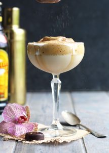 This Whipped Coffee Martini has a creamy topping made by mixing instant coffee, sugar and water.  The addition of vanilla vodka and Kahlua with a dusting of cocoa powder make it a delectable treat.