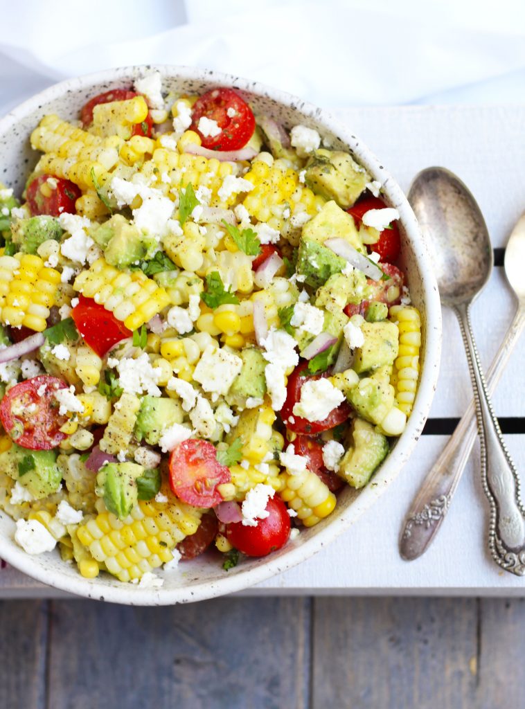This Corn Salad with Avocado is so flavorful with cherry tomatoes, feta cheese and a honey lime dressing.  Serve it fresh for summer BBQ's for an easy side dish that will be a new family favorite.