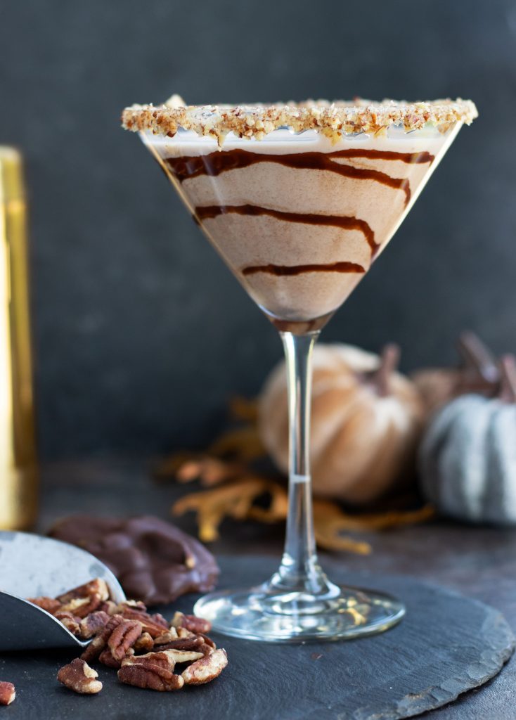 This Chocolate Turtle Martini with Pecan Whiskey, Crème de Cacao and Butterscotch Schnapps is a decadent cocktail that is perfect for entertaining.  It gets topped off with a caramel and rim with chopped pecans and a swirl of chocolate sauce.