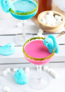 These Easter Peep Martinis have a sweet, marshmallow flavor that doesn't overpower.  The addition of your favorite pastel colors with a candy Peep garnishment and green sugar rim makes these perfect for spring celebrations.