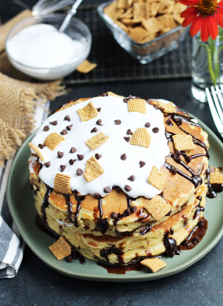 These S'mores Pancakes are pure breakfast bliss with Golden Grahams and chocolate chips in the batter with a topping of marshmallow cream and chocolate sauce.